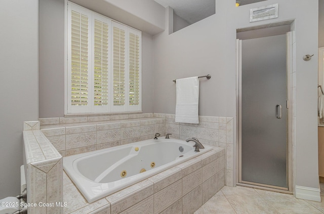 2351 Stonebridge Dr, Rockledge, FL 32955 - bathroom featuring a stall shower, a jetted tub, and tile patterned floors