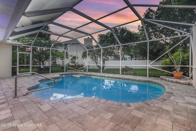 2351 Stonebridge Dr, Rockledge, FL 32955 - pool at dusk with a fenced backyard, a patio, and a lanai