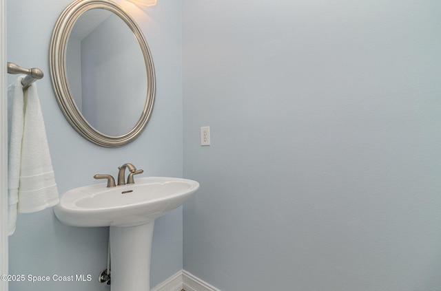2351 Stonebridge Dr, Rockledge, FL 32955 - bathroom featuring a sink and baseboards