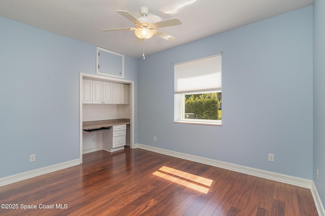 2351 Stonebridge Dr, Rockledge, FL 32955 - unfurnished bedroom featuring built in study area and dark wood finished floors
