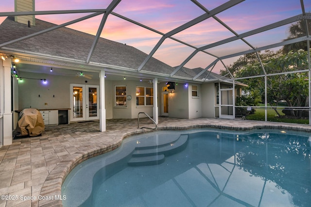 2351 Stonebridge Dr, Rockledge, FL 32955 - pool at dusk with an outdoor pool, french doors, and a patio