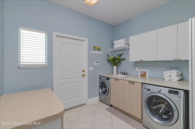 2351 Stonebridge Dr, Rockledge, FL 32955 - laundry area with cabinet space, light tile patterned flooring, and washing machine and dryer