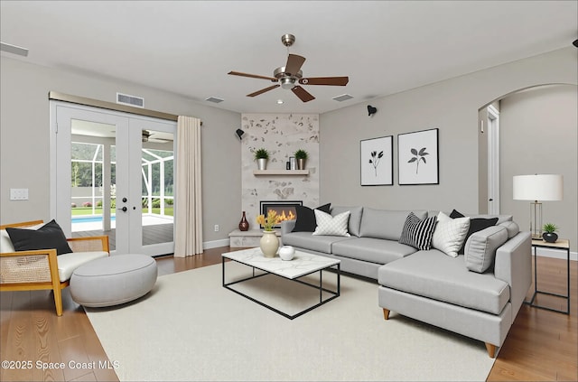 2351 Stonebridge Dr, Rockledge, FL 32955 - living room featuring a ceiling fan, french doors, arched walkways, and wood finished floors