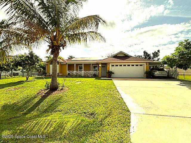 961 Haas Ave NE, Palm Bay, FL 32907 - single story home featuring a garage, covered porch, a front lawn, and concrete driveway