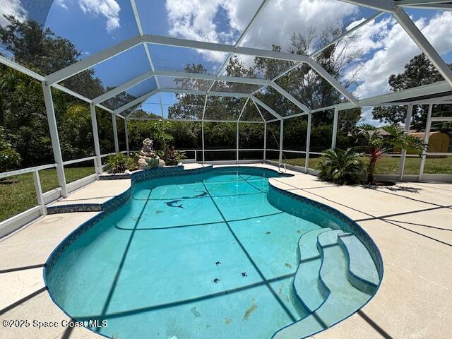 961 Haas Ave NE, Palm Bay, FL 32907 - swimming pool featuring glass enclosure and a patio