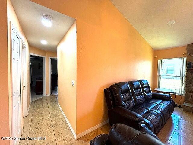 961 Haas Ave NE, Palm Bay, FL 32907 - living area with lofted ceiling and baseboards