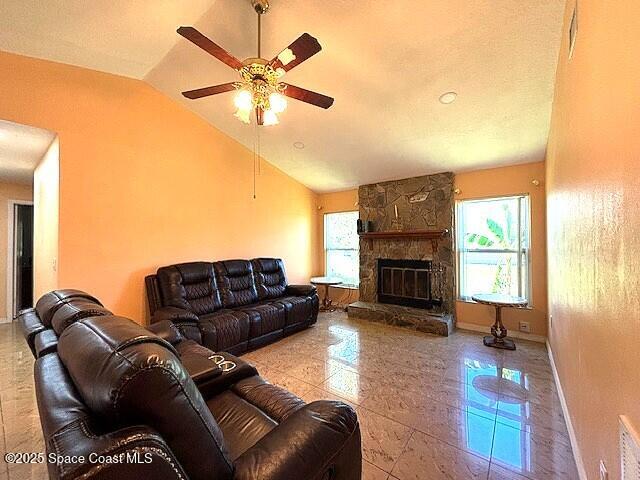 961 Haas Ave NE, Palm Bay, FL 32907 - living room with lofted ceiling, ceiling fan, and a fireplace