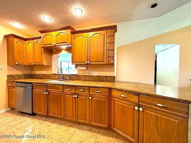 961 Haas Ave NE, Palm Bay, FL 32907 - kitchen featuring stainless steel dishwasher, brown cabinetry, dark stone counters, a textured ceiling, and recessed lighting