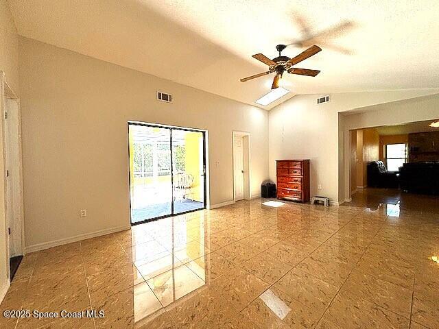 961 Haas Ave NE, Palm Bay, FL 32907 - unfurnished living room with vaulted ceiling and a ceiling fan