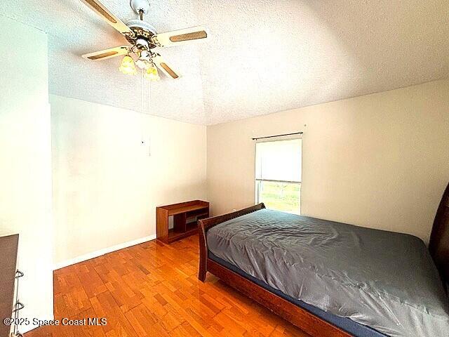 961 Haas Ave NE, Palm Bay, FL 32907 - bedroom featuring wood finished floors and a ceiling fan
