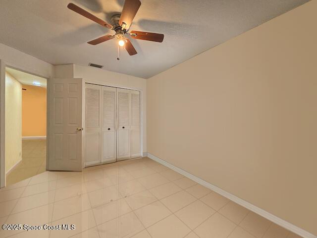 961 Haas Ave NE, Palm Bay, FL 32907 - unfurnished bedroom featuring a closet and a ceiling fan