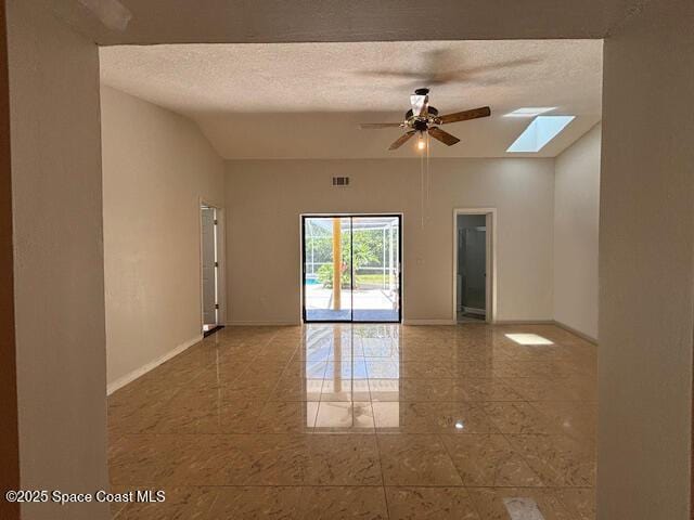 961 Haas Ave NE, Palm Bay, FL 32907 - unfurnished room featuring ceiling fan, a skylight, lofted ceiling, and a textured ceiling
