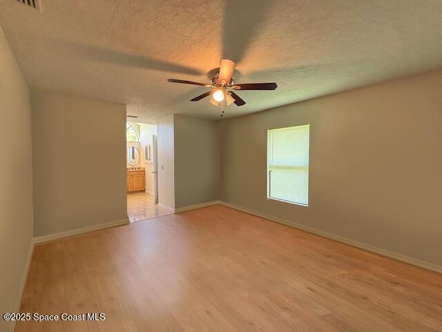 961 Haas Ave NE, Palm Bay, FL 32907 - spare room featuring ceiling fan, light wood finished floors, and a textured ceiling