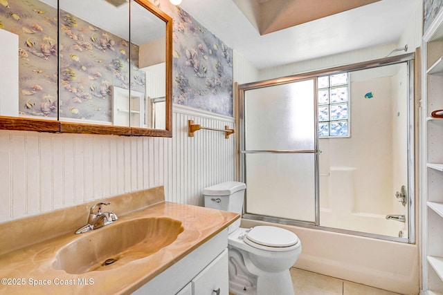 1081 Sunswept Rd NE, Palm Bay, FL 32905 - bathroom with vanity, a wainscoted wall, enclosed tub / shower combo, tile patterned floors, and wallpapered walls