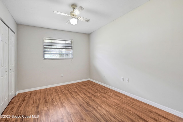 1081 Sunswept Rd NE, Palm Bay, FL 32905 - unfurnished bedroom with a closet, wood finished floors, and ceiling fan