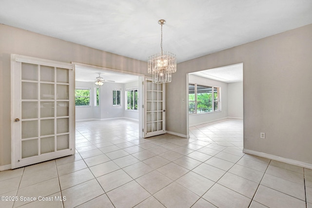 1081 Sunswept Rd NE, Palm Bay, FL 32905 - unfurnished room featuring plenty of natural light, light tile patterned flooring, a chandelier, and ceiling fan