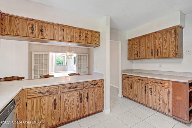 1081 Sunswept Rd NE, Palm Bay, FL 32905 - kitchen with dishwasher, light tile patterned floors, light countertops, and brown cabinets