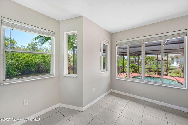1081 Sunswept Rd NE, Palm Bay, FL 32905 - empty room featuring healthy amount of natural light and light tile patterned floors