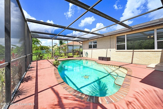 1081 Sunswept Rd NE, Palm Bay, FL 32905 - swimming pool with a patio area and glass enclosure