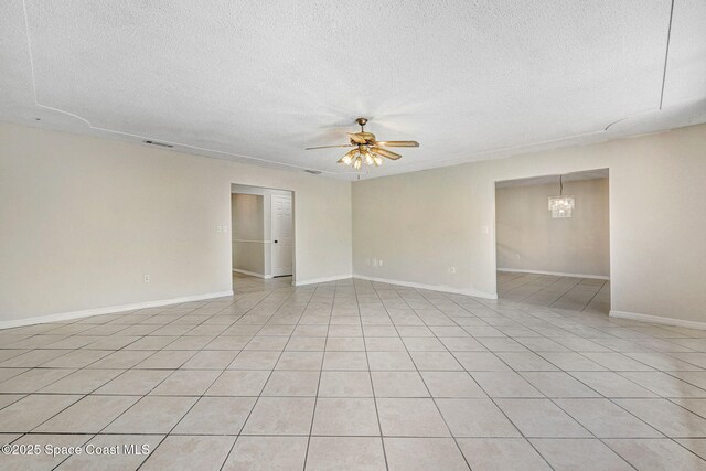 1081 Sunswept Rd NE, Palm Bay, FL 32905 - spare room with a textured ceiling, a ceiling fan, a chandelier, and light tile patterned floors