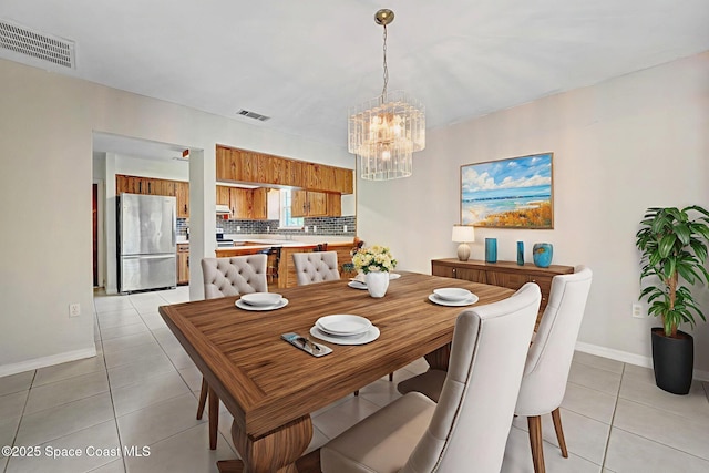 1081 Sunswept Rd NE, Palm Bay, FL 32905 - dining room featuring light tile patterned flooring and a chandelier