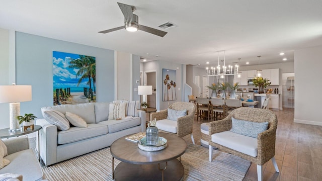 1997 Fuchsia Pl NW, Palm Bay, FL 32907 - living area featuring light wood-style floors, a chandelier, recessed lighting, and a ceiling fan