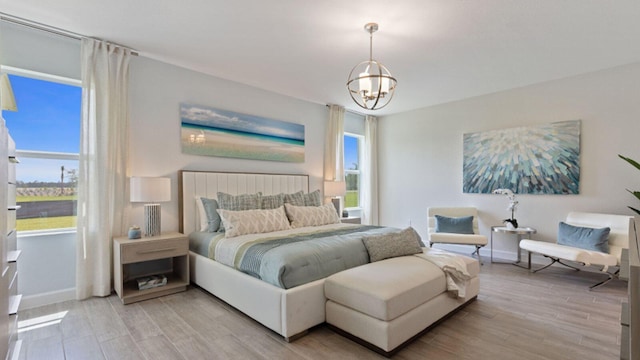 1997 Fuchsia Pl NW, Palm Bay, FL 32907 - bedroom featuring a chandelier and light wood-style floors