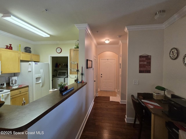 6440 Borasco Dr Unit 2506, Melbourne, FL 32940 - kitchen featuring white appliances, dark wood finished floors, ornamental molding, washing machine and dryer, and arched walkways