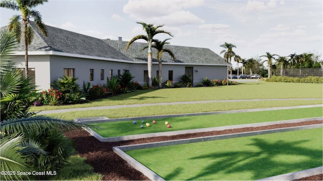 2643 Antarus Dr NW, Palm Bay, FL 32907 - back of property with stucco siding, a yard, and roof with shingles