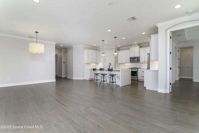 3975 Archdale St, Melbourne, FL 32940 - living room with recessed lighting, dark wood-style floors, and crown molding