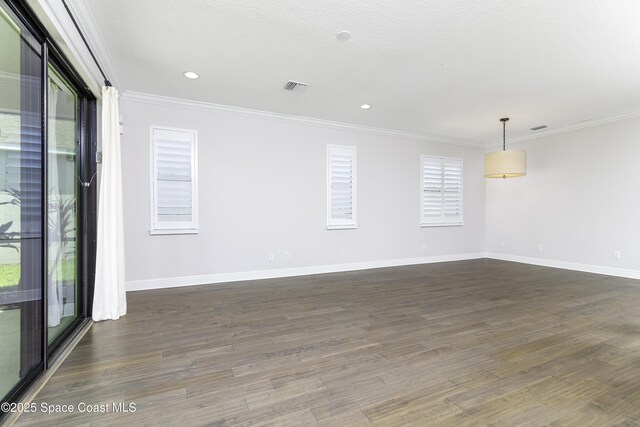 3975 Archdale St, Melbourne, FL 32940 - spare room with dark wood-type flooring, ornamental molding, and recessed lighting