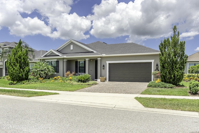 3975 Archdale St, Melbourne, FL 32940 - view of front facade featuring stucco siding, a garage, decorative driveway, and a front yard