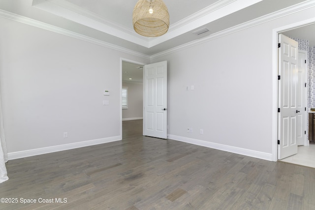 3975 Archdale St, Melbourne, FL 32940 - empty room featuring a raised ceiling, wood finished floors, and crown molding