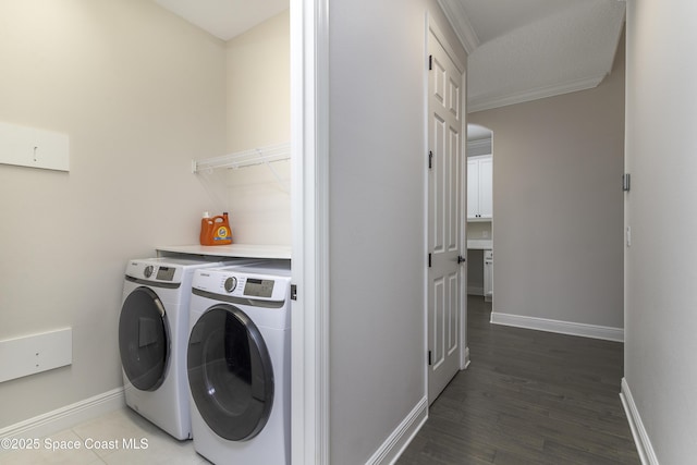 3975 Archdale St, Melbourne, FL 32940 - washroom featuring washer and dryer, crown molding, and light wood-type flooring