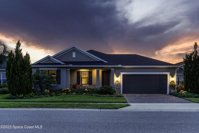 3975 Archdale St, Melbourne, FL 32940 - ranch-style home featuring an attached garage, stucco siding, driveway, and a porch