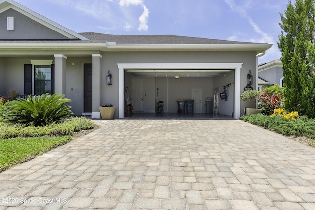 3975 Archdale St, Melbourne, FL 32940 - view of front of property featuring stucco siding, decorative driveway, and a garage