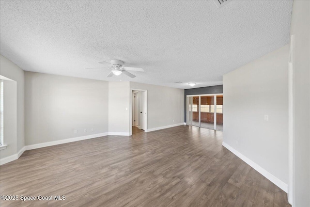 1871 Talloak Rd, Melbourne, FL 32935 - unfurnished living room featuring ceiling fan, wood finished floors, and a textured ceiling