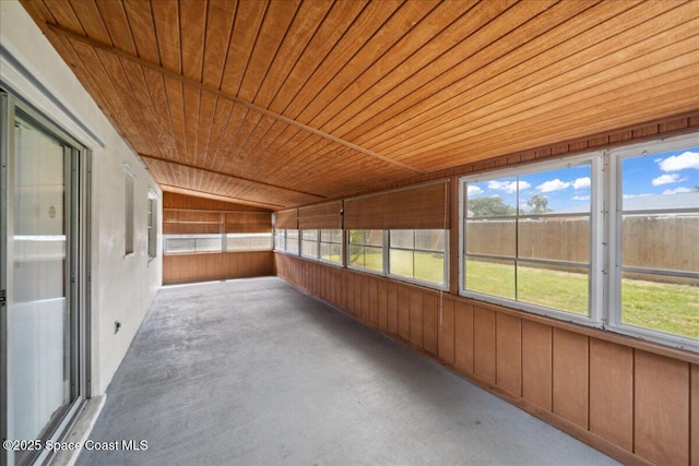 1871 Talloak Rd, Melbourne, FL 32935 - unfurnished sunroom with unfinished concrete flooring, wood ceiling, wood walls, and healthy amount of natural light