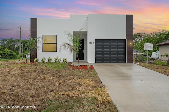 1889 Warton Ave SE, Palm Bay, FL 32909 - view of front facade with driveway, stucco siding, and a garage