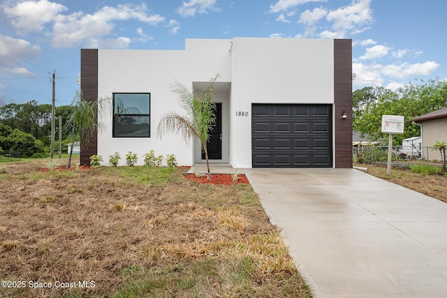 1889 Warton Ave SE, Palm Bay, FL 32909 - view of front of home with stucco siding, driveway, and an attached garage
