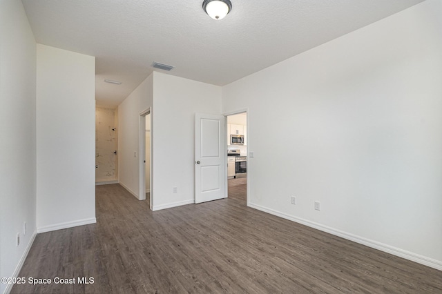 1889 Warton Ave SE, Palm Bay, FL 32909 - unfurnished room featuring dark wood-style flooring and baseboards