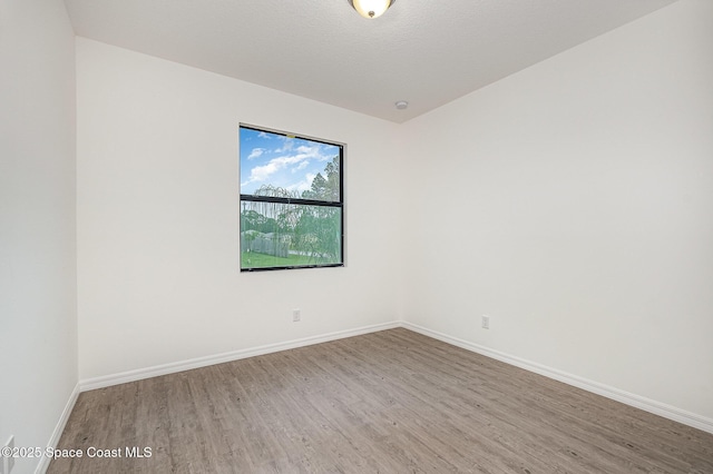 1889 Warton Ave SE, Palm Bay, FL 32909 - spare room featuring wood finished floors and baseboards