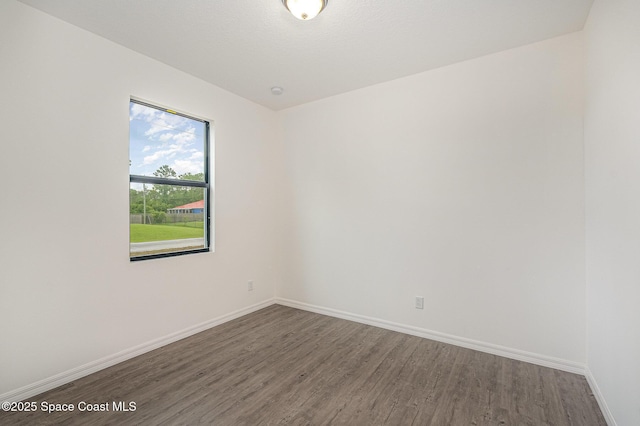 1889 Warton Ave SE, Palm Bay, FL 32909 - spare room featuring dark wood-type flooring