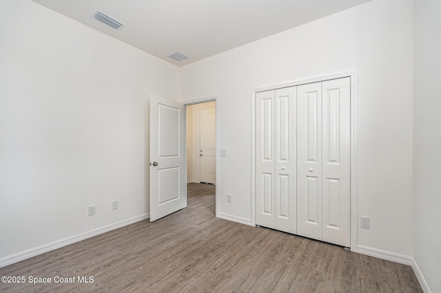 1889 Warton Ave SE, Palm Bay, FL 32909 - unfurnished bedroom with wood finished floors and a closet