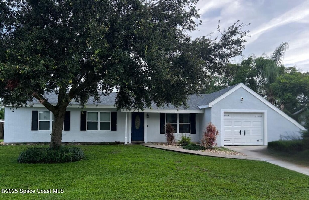 1355 Cromey Rd NE, Palm Bay, FL 32905 - single story home featuring a garage, concrete driveway, a front lawn, and stucco siding