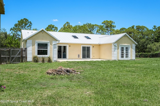 2749 Digby Rd SE, Palm Bay, FL 32909 - back of house featuring stucco siding, french doors, and a metal roof