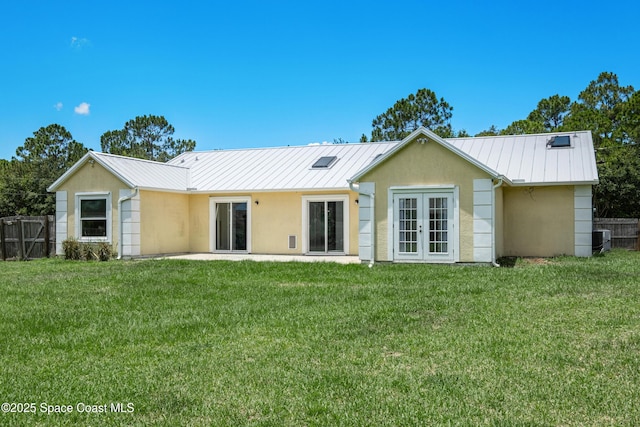 2749 Digby Rd SE, Palm Bay, FL 32909 - rear view of property with french doors, stucco siding, and a metal roof