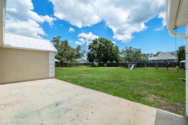 2749 Digby Rd SE, Palm Bay, FL 32909 - fenced backyard featuring a playground and a patio area