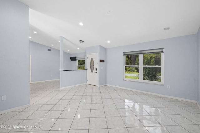 2749 Digby Rd SE, Palm Bay, FL 32909 - unfurnished living room featuring vaulted ceiling, recessed lighting, and light tile patterned floors