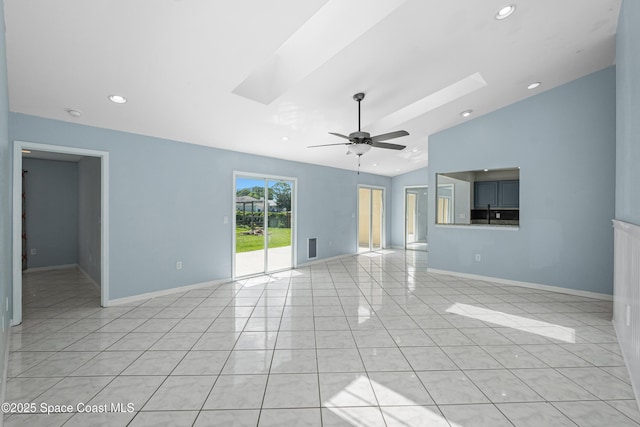 2749 Digby Rd SE, Palm Bay, FL 32909 - unfurnished living room featuring vaulted ceiling, ceiling fan, recessed lighting, a skylight, and light tile patterned floors